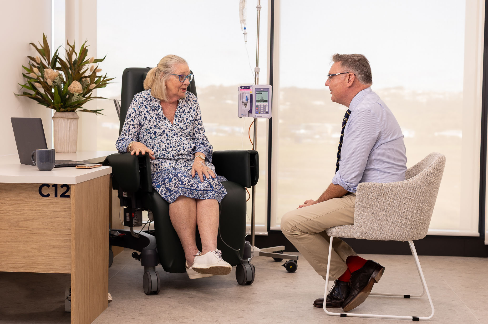 Female patient receiving an infusion while speaking with a clinician at The Solace Clinic in Maroochydore.